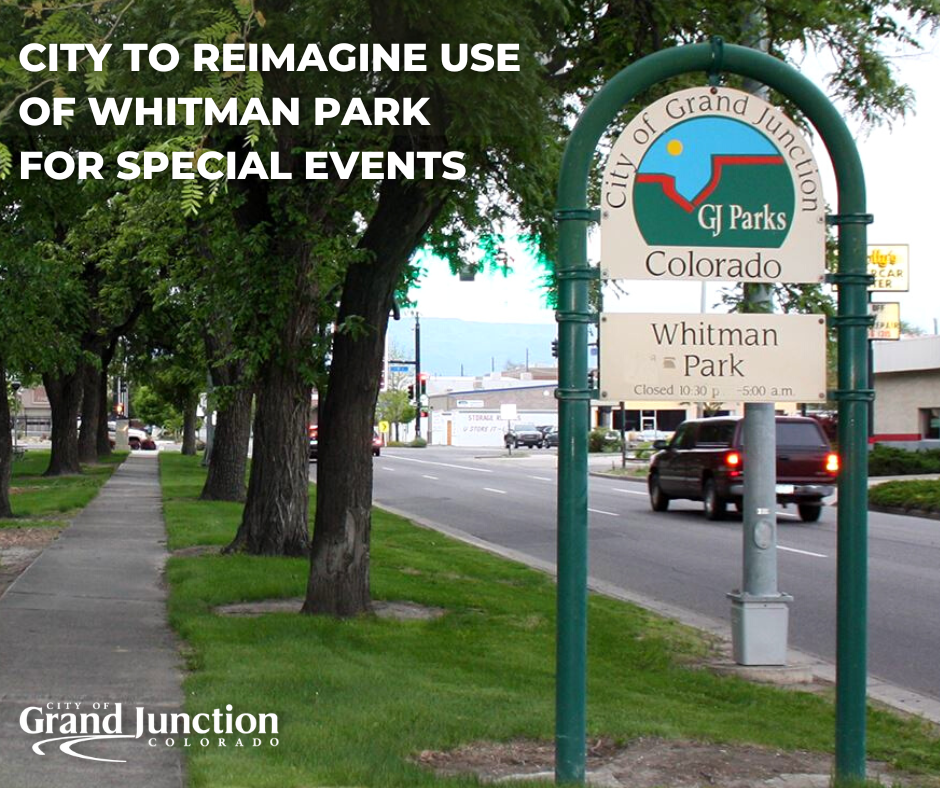 Trees behind park sign with a sidewalk and street. Text on the graphic. 