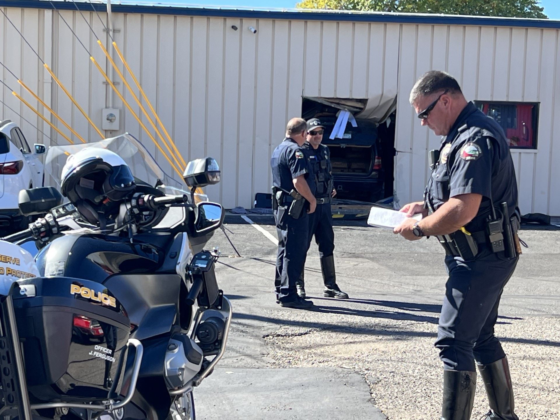 Officers on scene of a crash involving vehicle into building