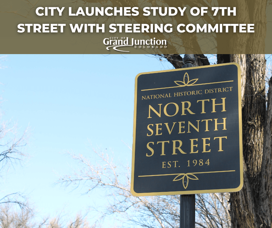 A historical sign along 7th St. with a tree in the background. 