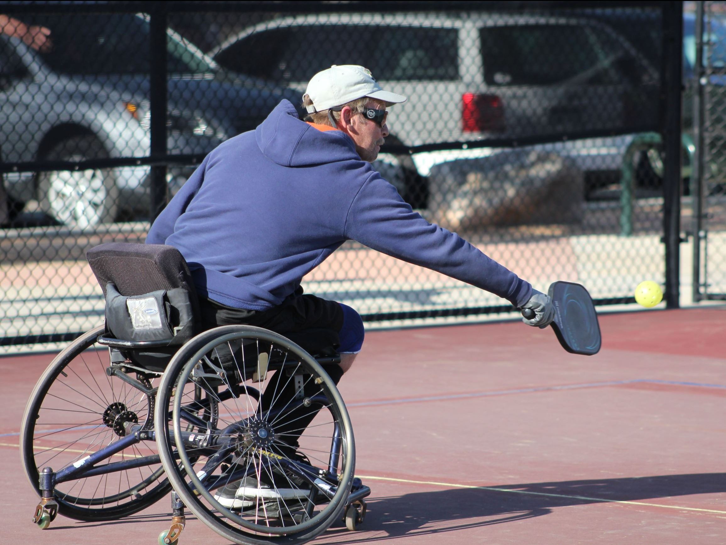 Man in wheelchair playing pickleball