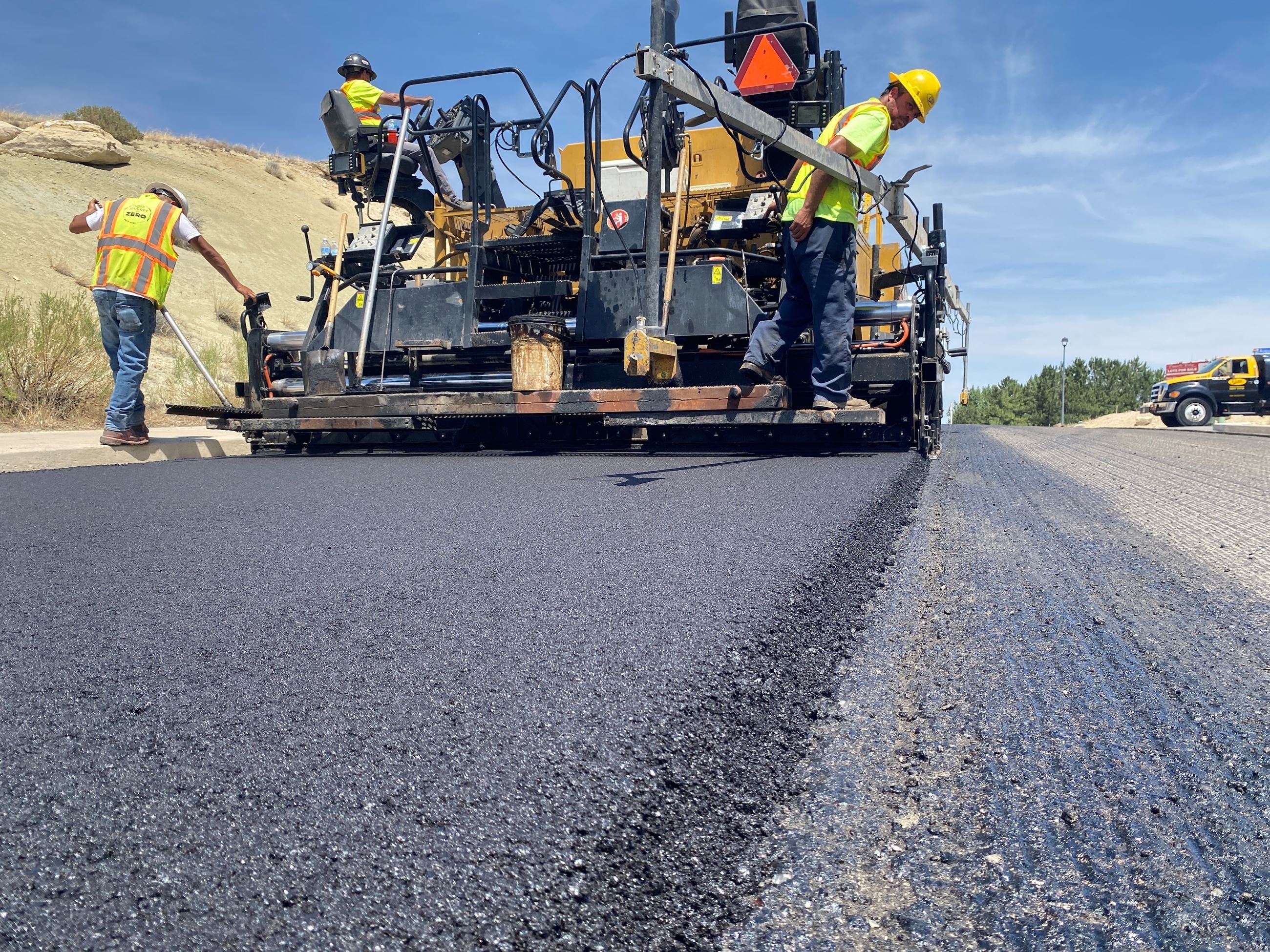 Crews chip sealing a City road