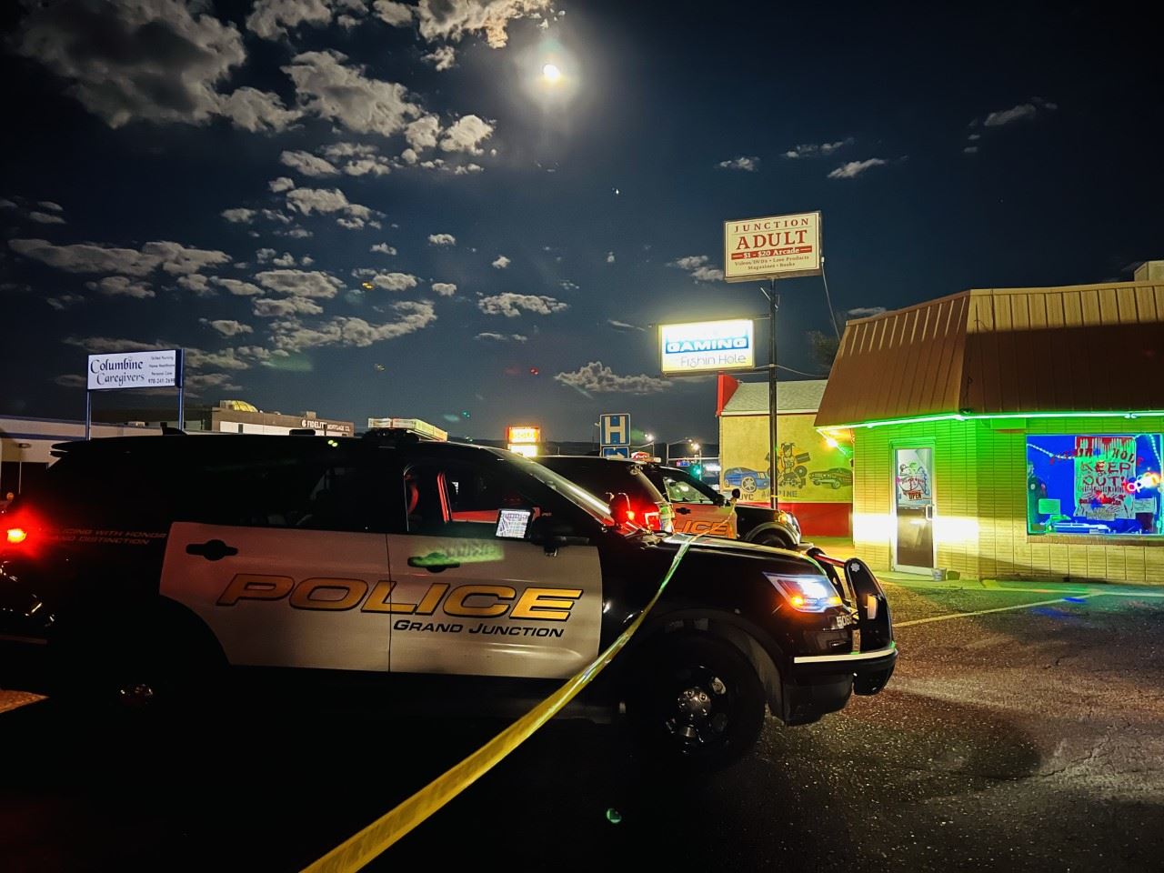 black and white police cars in front of a business