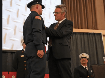 Picture of a badge pinning during the graduation ceremony