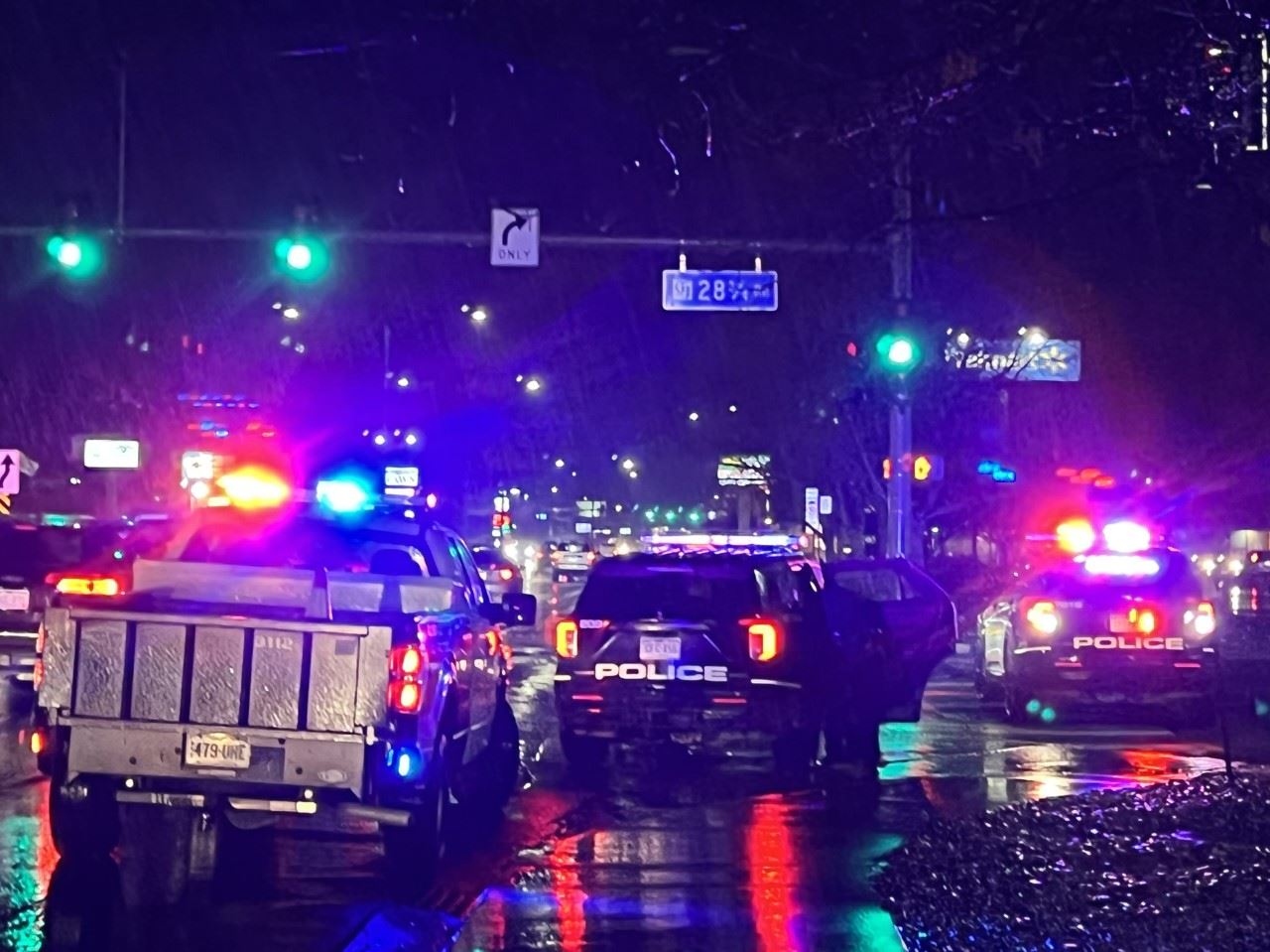three police vehicles with lights on at night 