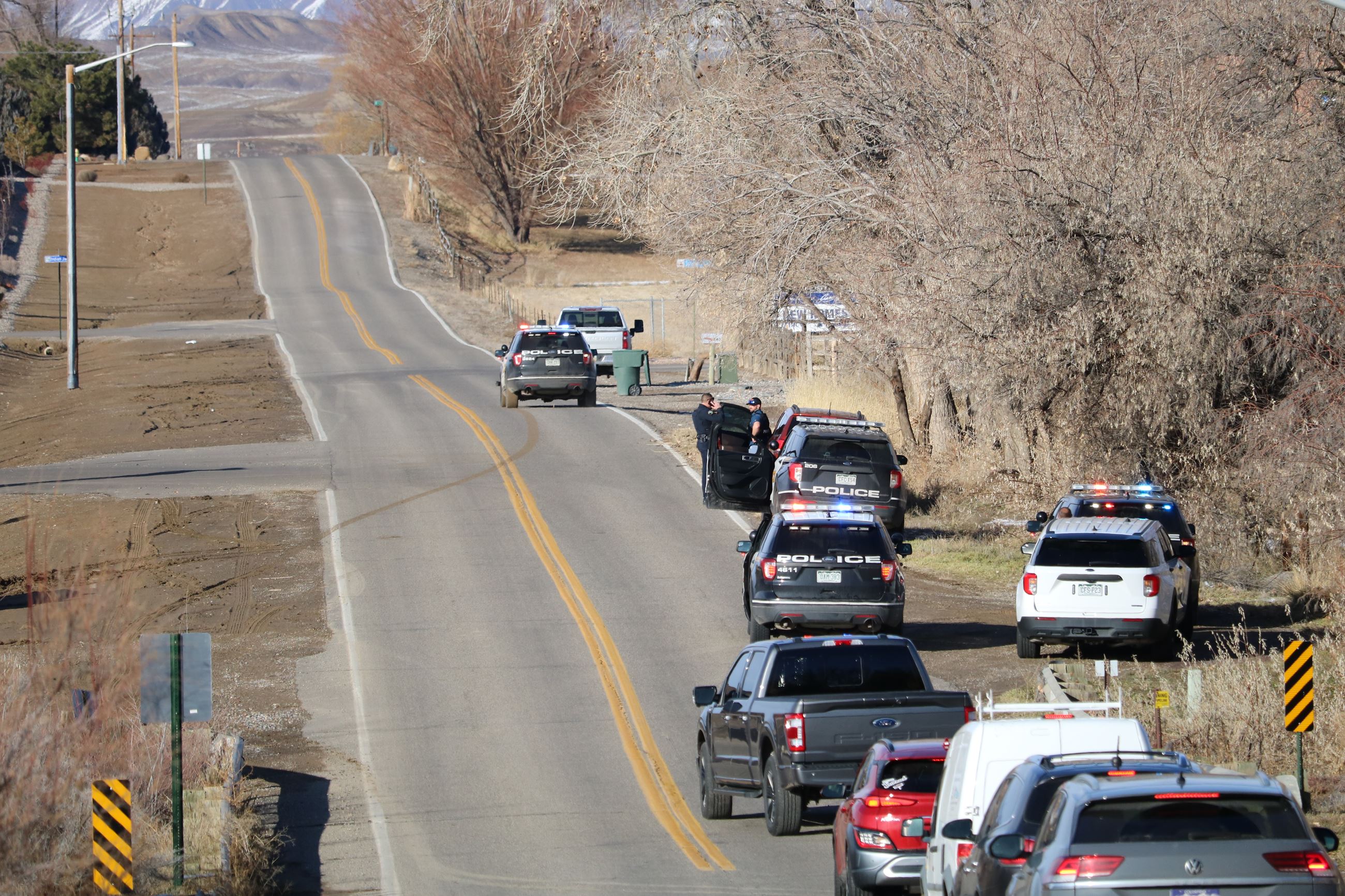 Police vehicles and other vehicles on stretch of road