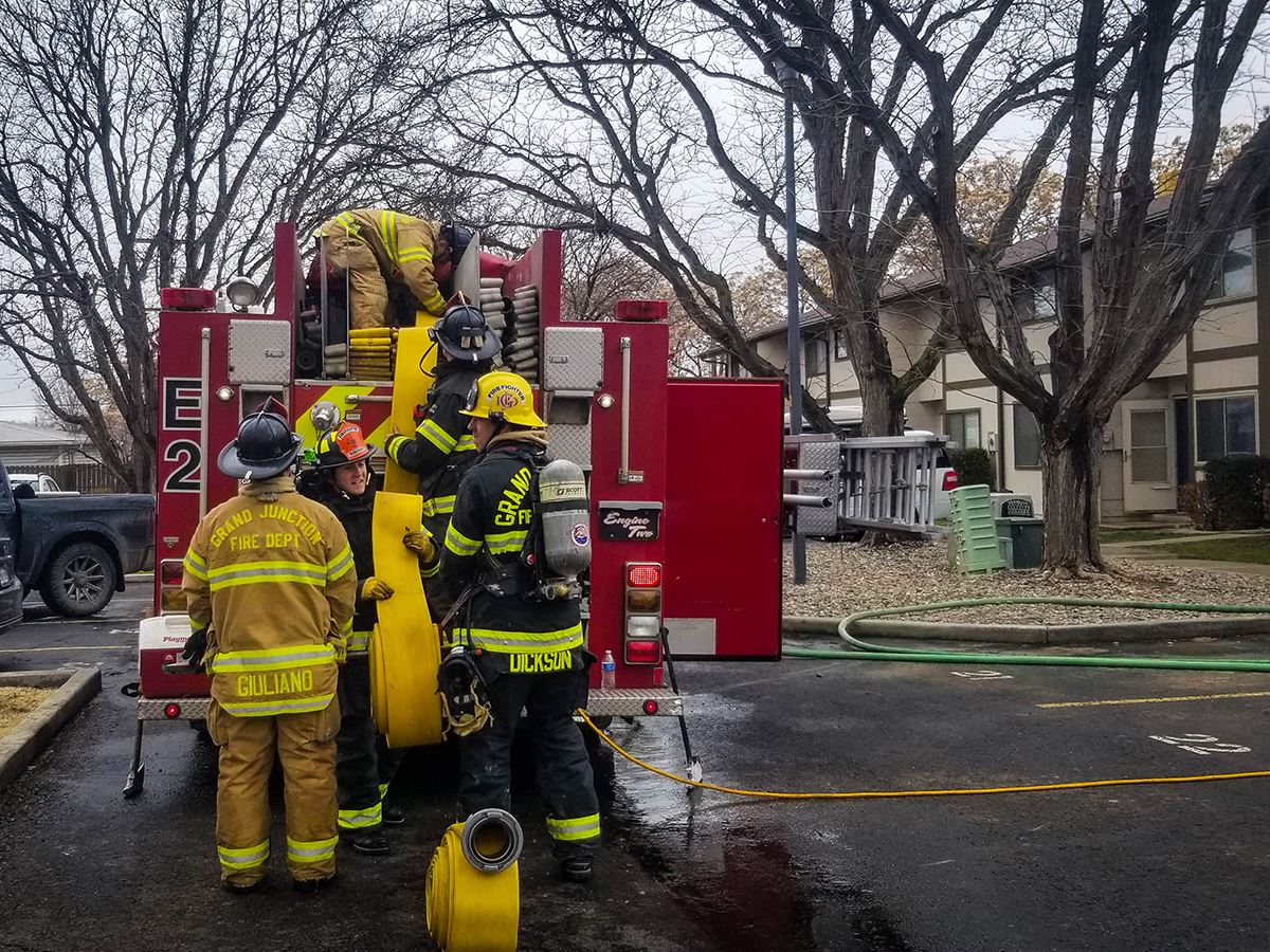 Engine 2 and firefighters loading hose