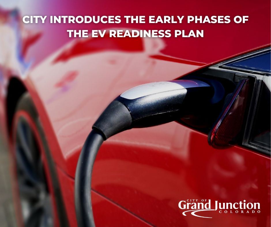 Red car showing electric charging plug with City logo in black
