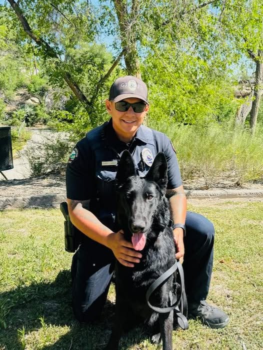 Officer with black dog